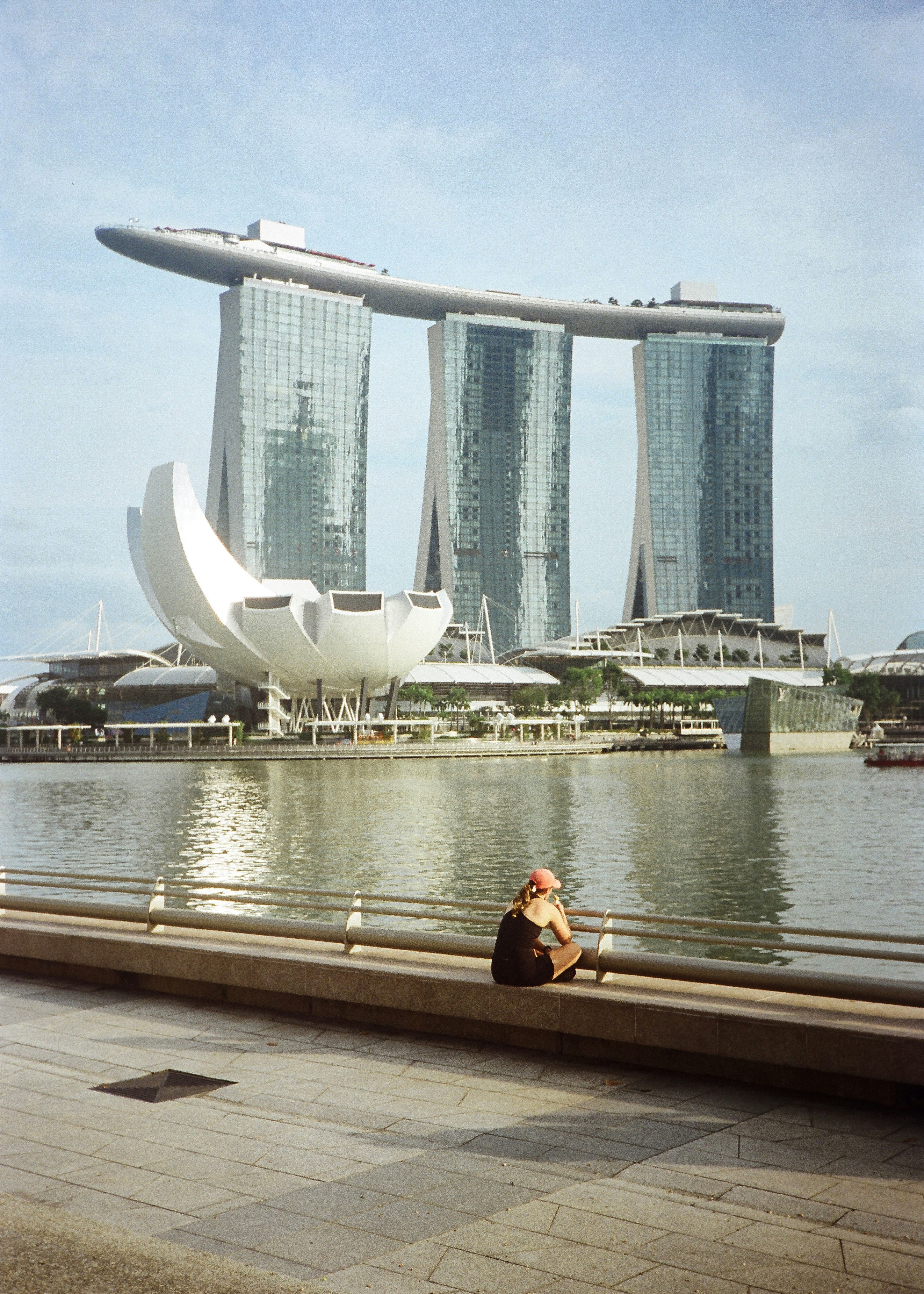 beach pier leading to ocean with waves splashing on it